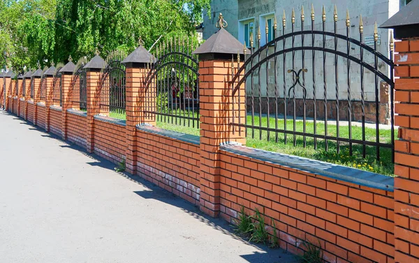 depositphotos 337207438 stock photo metal fence red brick street